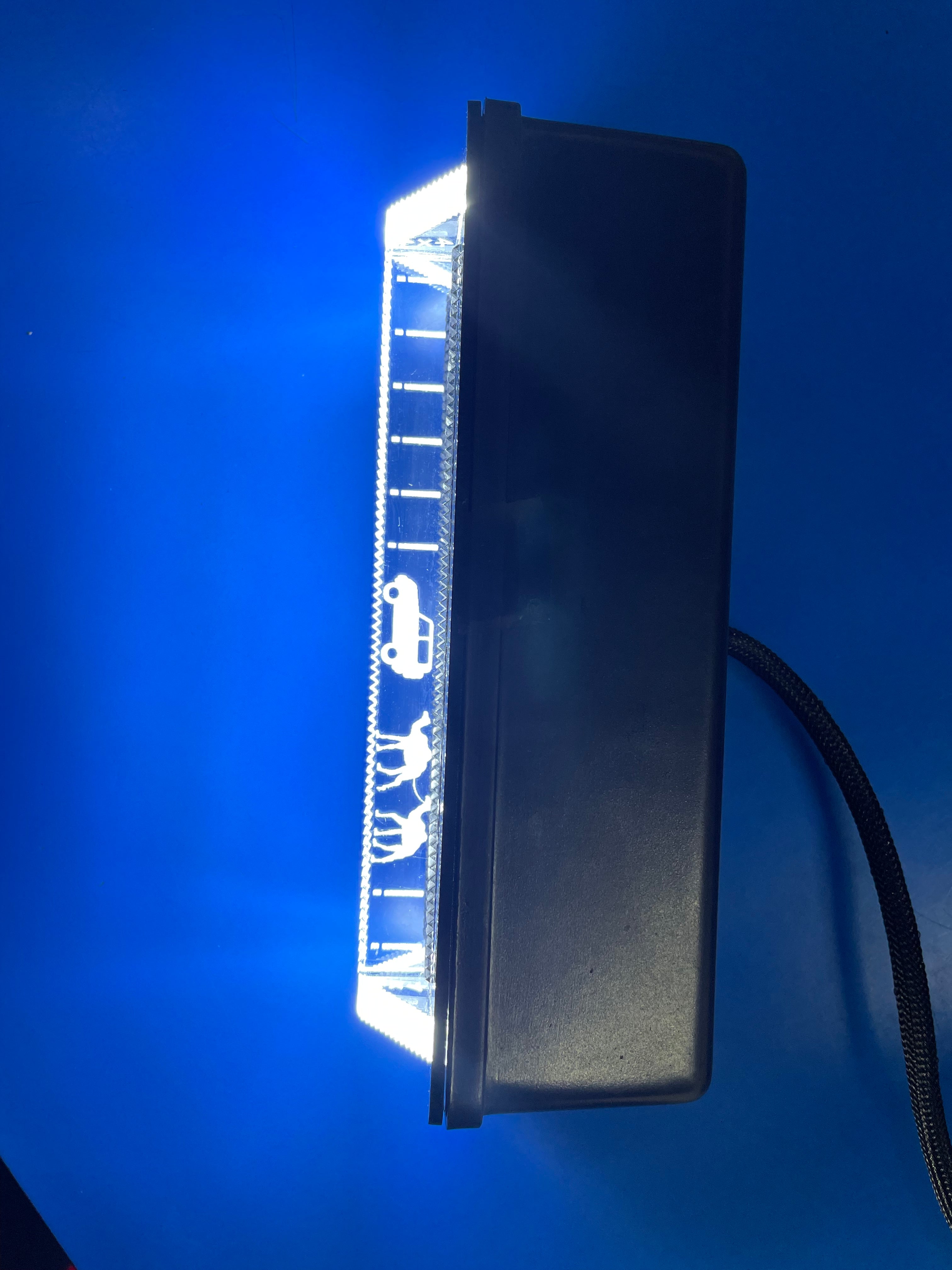 Rectangular LED light bar with symbols on a blue background