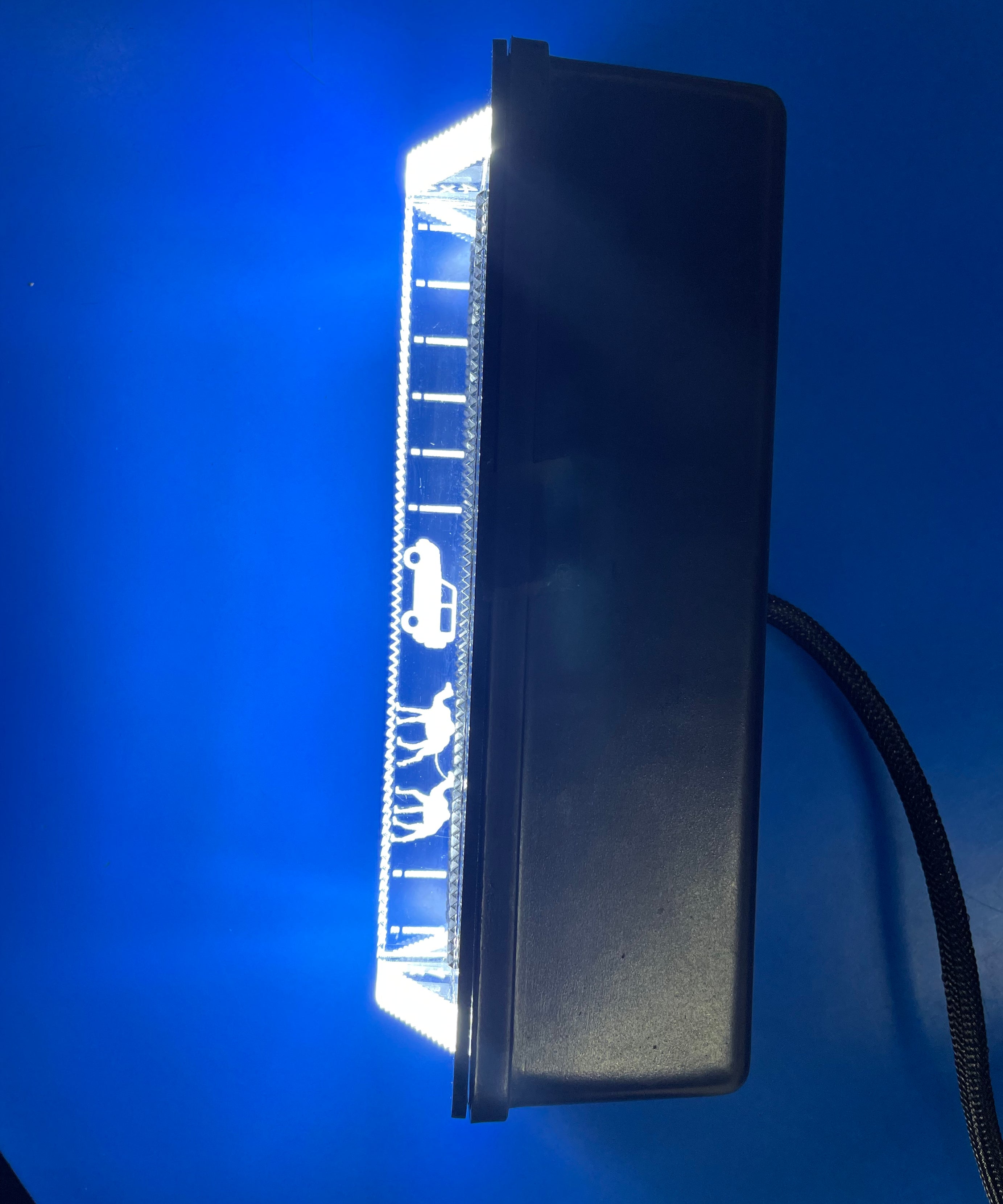 Rectangular LED light bar with symbols on a blue background

